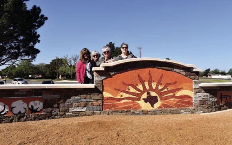 MOSAICART - The Levelland Chamber of Commerce held a ribbon cutting on Tuesday for the Governor’s Community Achievement Award which resulted in a mosaic monument at the southeast corner of Highway 385 and Clubview Drive. Pictured is the artist Pauline Mills and her helpers Kelly Reynolds, Shelly Carver and Nell Elston who spent three months putting the monument together. (Staff photo by Emily Campos)