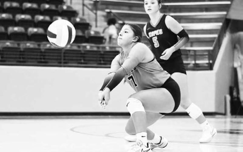 DIGGIN’ IT – Marlee Molina makes the dig while her teammate Braedyn Reyna watches during a volleyball game against Vega this past Tuesday. That would be game one of a doubleheader in Littlefield, where they also played Littlefield. They won both matchups, 2-1 and 3-0. (Staff Photo by Jentezen Smith)