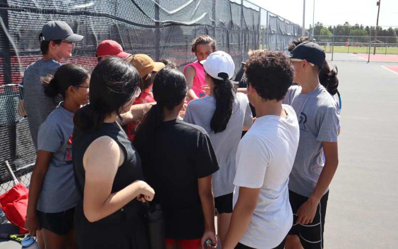 BREAK - Levelland Tennis camp breaks it out at the end of practice during Levelland two-a-days. (Staff Photo by Aalijah Soliz)