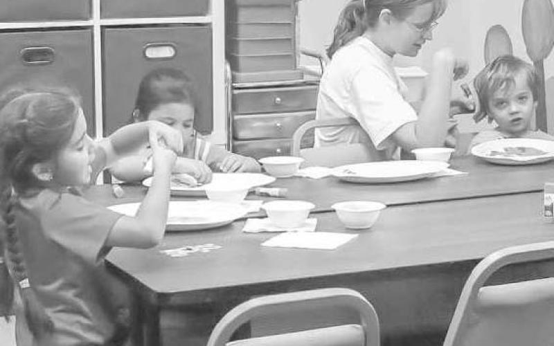 HAVING FUN - Kids were working on their porjects while eating donut holes with their parents. (Staff Photo by Aalijah Soliz)