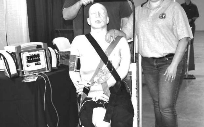 DUMMY GEORGE:There was a Dummy they named George at the Fall 2023 Career Exploration Event on Thursday at the Mallet Event Center. The dummy was to teach medical procedure to the students as they stopped by the booth for information. Pictured is Scott and Nicole Crabey.(Staff photo by Emily Campos)