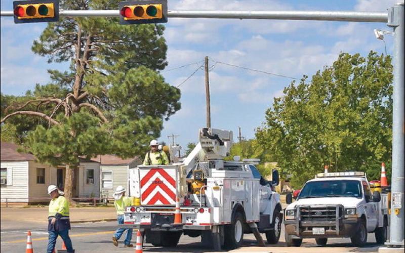 ROUTINE WORK - Crews with the Texas Department of Transportation were doing routine maintenance to traffic lights located along College Avenue Thursday afternoon. Crews focused on working on traffic light boxes while trying not to impede traffic during the busier hours of the day. (Staff photo by Emily Campos)