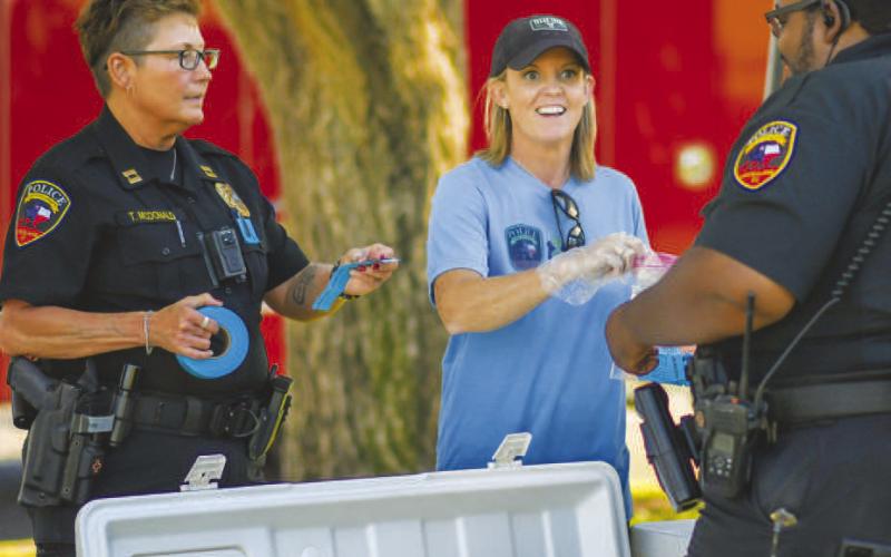 BLUE &amp; YOU - The Blue and You Organization and the Levelland Police Department had a successful outing hosting a Texas Night Out event at the Double U Park in Levelland. Community members across Levelland were encouraged to attend and become more familiar with the individuals in public safety roles. Pictured are LPD Captain Tammy McDonald, Blue and You member Amber Smith and LPD Officer Cory Foley. (Staff photo by Dom Puente)