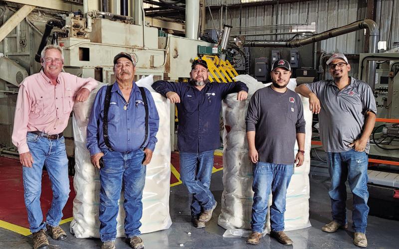 FIRST BALE - Willingham Gin located in Morton is beginning to ramp up work as they put together their first bale of the season in Cochran County. Pictured from left to right are: Gin Manager Todd Willingham, Gin Superintendent Canuto Tarango, Head Ginner Octavio Garay, Gin Helper Jonathon Nava and Head Press Michael Perez. The producer resulting in this seasons first bale was Austin McCasland.(Photo courtesy of Alex Arellano)