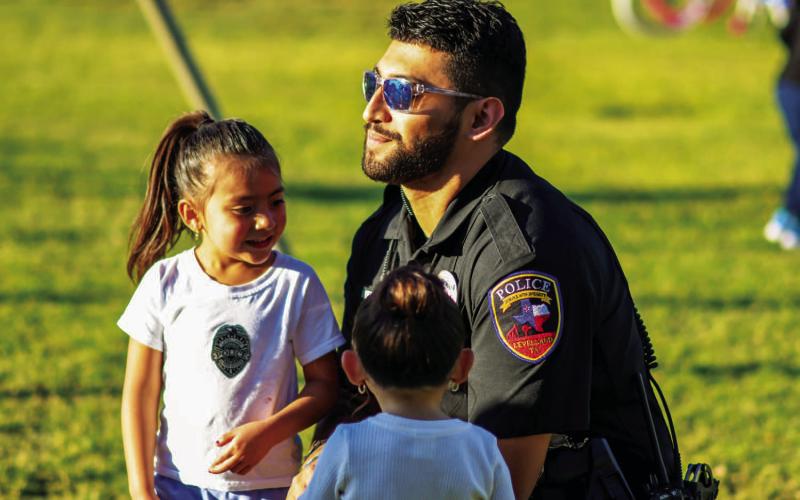 BIG SMILES - During the Texas Night Event held Tuesday at Double U Park in Levelland, children and adults were encouraged to take photos with public safety personnel to get a chance to win door prizes. The event was held by the Blue and You Organization and the Levelland Police Department. (Staff photo by Dom Puente)