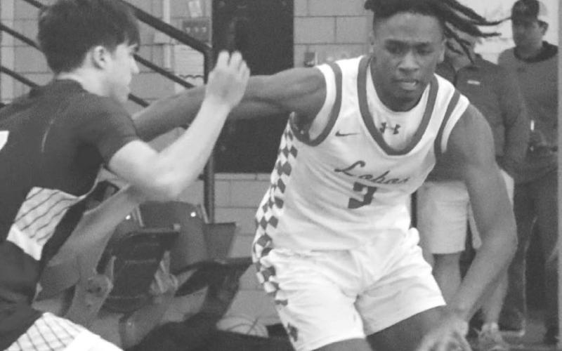 DETERMINATION - Levelland Lobo Eryk Jones broke the full court press with his combination of speed, strength and size during the teams first game of the Littlefield tournament against the Hale Center Owls. (Staff photo by Aalijah Soliz)