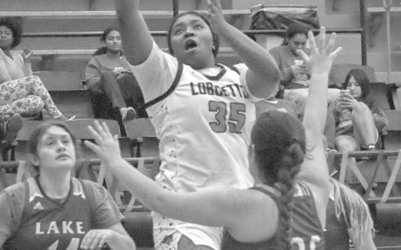 DOWN LOW - Levelland Loboette Sydnii Joyce shot the ball over three Lakeview Maidens during the teams contest last Friday on senior night. (Staff photo by Aalijah Soliz)