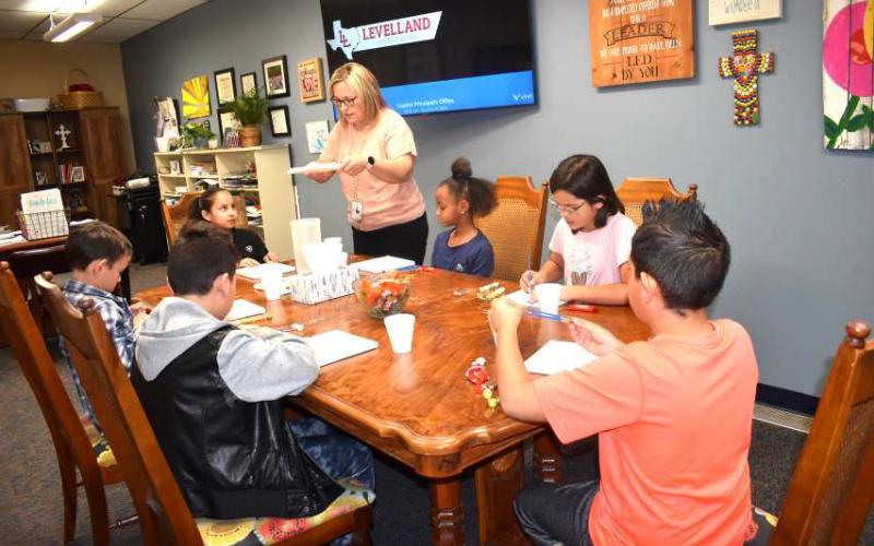 PAINTING FUN- Capitol Elementary rewards Kids w/Character every nine weeks. Students are choosen by their teachers. The students are selected for showing respect and being kind.This past Tuesday the students painted on canvases while having a treat of their choice and listening to music. Pictured in no particular order are Principal Joanna Runkles, and 4th grade students Marisol Castillo, Marcilyn Woods, Jazmin Marryfo, Declan Jaramillo, Raymond Hernandez and Dylan Slape. Runkles.(Staff photo by Emily Campo