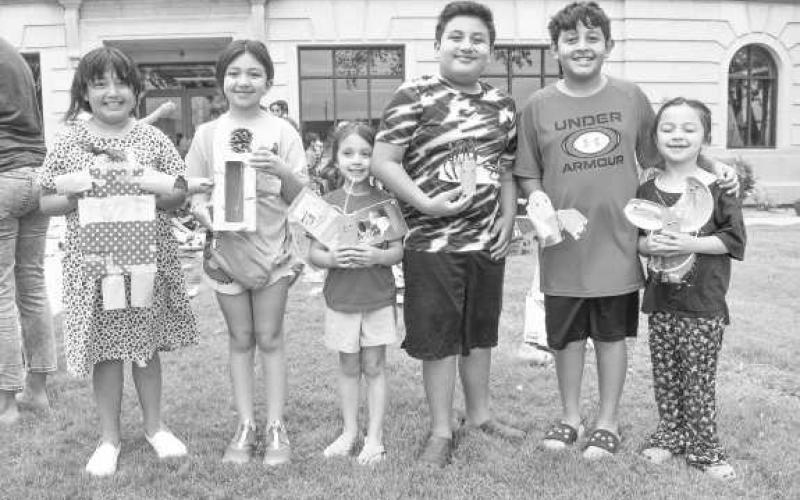 TRASH ART- On Wendesday, the Hockley CountyLibrary Summer Reading Program had children in attendance turn trash in to art. Pictured from left to right are: Davennee Aubree Declan, Alivia, Aubree, and David Jaramillo. (Staff photo by Emily Campos)