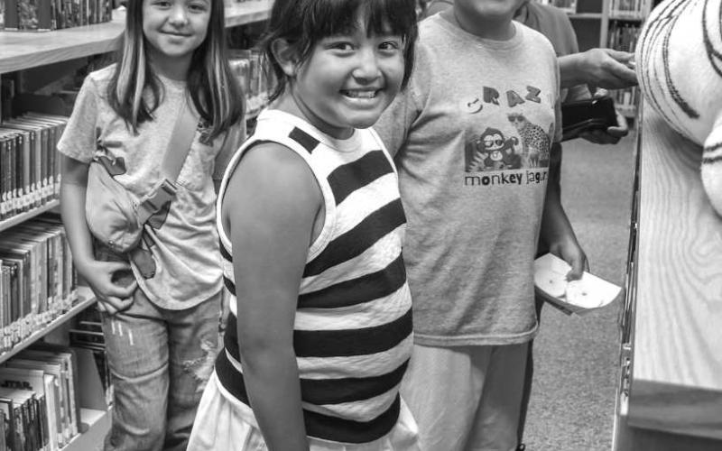 SEARCH FOR A GOOD BOOK - The Hockley County Library continues to have its summer program on Wednesdays at the library. Pictured is: Davenee, Aubree and Declan Jaramillo who participated in the reading program on Wednesday. The three took their time looking for books they liked after the program activities. (Photo courtesy of Emily Campos)