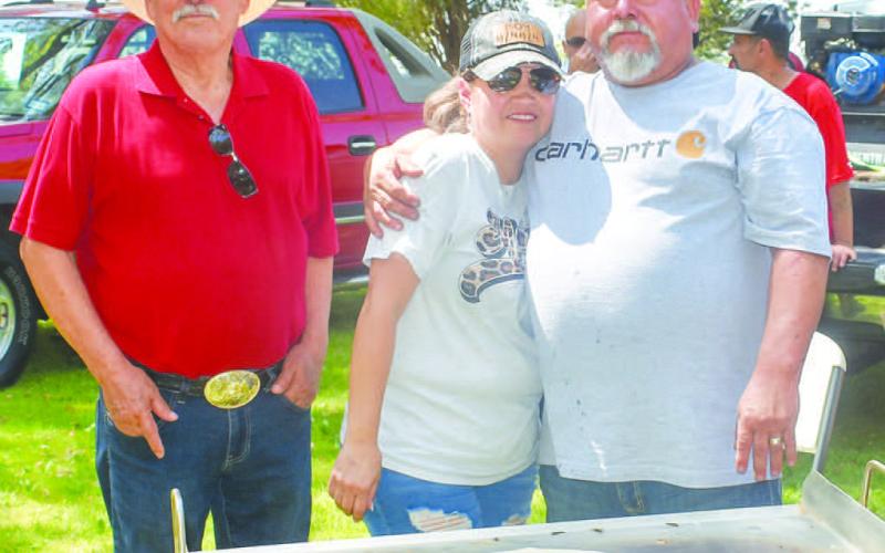 COOKING BRISKET - Grilling a brisket at the Jamaica in Morton was Oscar and wife Sonnya Alvarado and Enocencio Cruz . The booth was one of many sponsored by the St. Ann’s Caholic Church (Photo courtesy of Emily Campos)