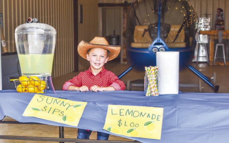 SUNNY SIPS LEMONADE- Wyatt Dunn was out selling lemonade on Wednesday. Dunn spent his own money to buy the lemonade, lemons, cups and straws it coast $1 a cup. Dunn said he hopes to sell enough lemonade to buy a house boat to put out at Possum Kingdom Lake. (Photo courtesy of Emily Campos)