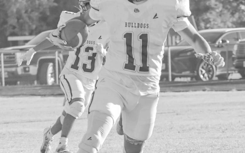 OUT MY WAY - Anton Bulldog Jose Avalos ran the ball to the right side of the field Sept 5 in the team’s win against the Dragons on the road. (Staff photo by Aalijah Soliz)