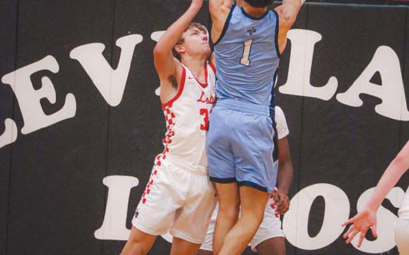 NO EASY SHOTS - Levelland Lobo Gage French contested the shot down low under the basket against the Greenwood Rangers last Tuesday at home. (Staff photo by Aalijah Soliz)