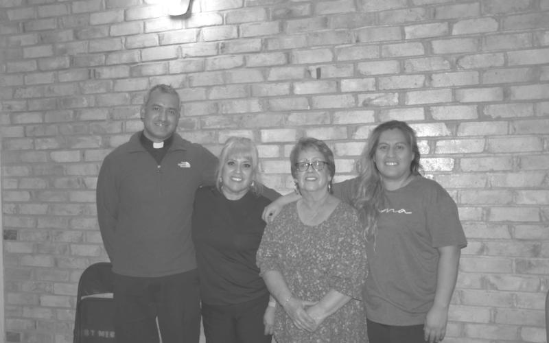 COMMUNITY THANKSGIVING--St. Michale’s Catholic Church in Levelland hosted their first community Thanksgiving dinner this past Monday. Volunteers donated and prepared food for the event. Members of the community showed up and enjoyed food and fellowship before the Thanksgiving holiday. Pictured are Father Johnathan Phillips, Lisa Gomez, Victoria Quezada and Veronica Muniz. (Staff photo by Myra Guerrero).