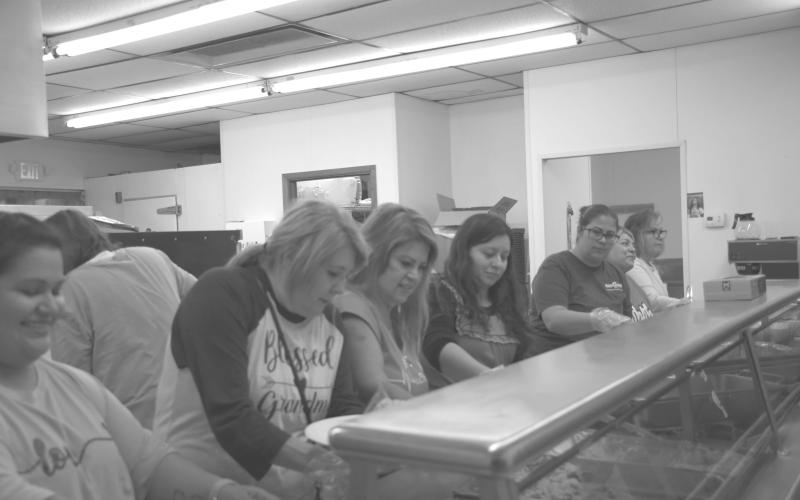 WORKING LADIES—Volunteers worked to keep everyone fed that came to the St. Michael’s Catholic Church for their first Community Thanksgiving dinner. Pictured from left to right are Valerie Martinez, Dina Goana, Chrissy Davila, Monica Negrete, Celia Corrales, Zoila Garcia and Dolores Quesada. (Staff photo by Myra Guerrero).