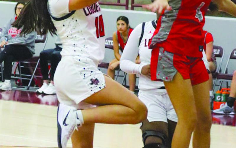 LAYUP - Levelland Loboette Emily Perez shot the ball with momentum driving into the paint during the team’s game against Denver City in the Littlefield Tournament. (Staff photo by Aalijah Soliz)