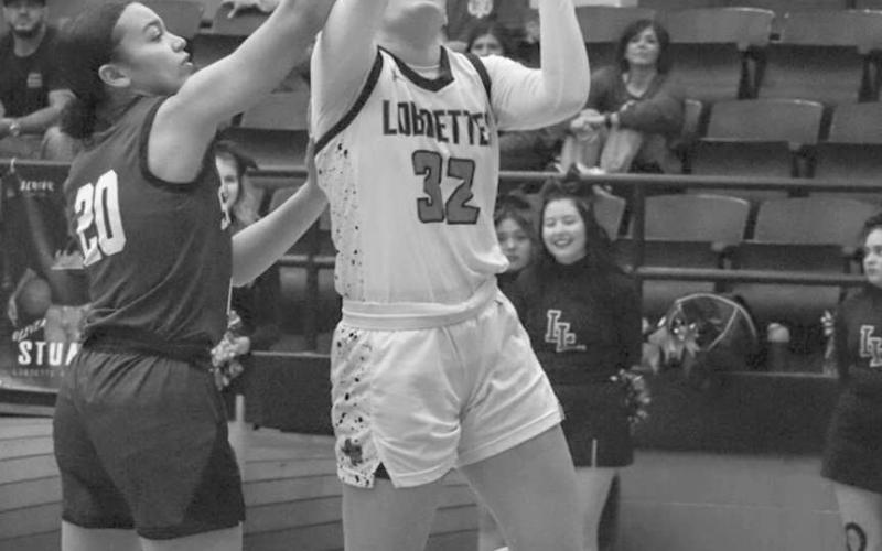 TOUGH SHOT - Levelland Loboette Emery Smith layed the ball up through the contact during the team’s game against Snyder at home during their Senior Night. (Staff photo by Aalijah Soliz)