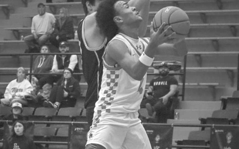 AND ONE - Levelland Lobo Bryson Golightly layed the ball up through the contact during the team’s game against the Tigers this past Tuesday night at home. (Staff photo by Aalijah Soliz)