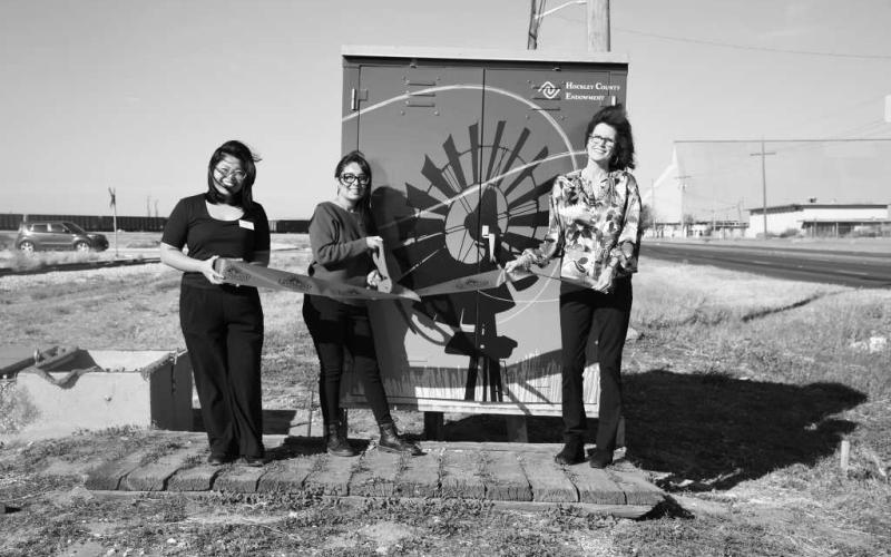 RAILROAD BUNGALOW - Pictured left to right are: Arra Delos Santos, Kim Rico and Cristal Issacks. The Levelland Chamber of Commerce held a Hockley County ribbon cutting ,celebrating the Endowment Bunglaow. It is newly rewrapped and can be seen by the railraod near Progressive Place and HWY 114. The project was made possible through the generous support of the Hockley COunty Endowment Grant Fund. (Staff photo by Hannah Woodrum)