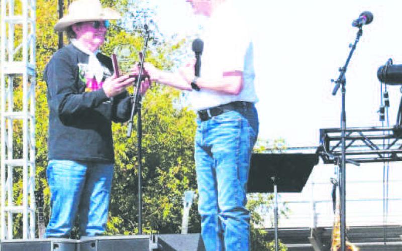 2025 DISTINGUISHEDALUMNI- South Plains College President Robin Satterwhite (right) presents the 2025 Distinguished Alumni Award to country music artist Gary P. Nunn during the SPC Creative Arts Department’s 50th Anniversary Celebration on Nov. 1. Established in 1987, the award honors outstanding alumni who have made significant contributions to their community. (SPC Photo)