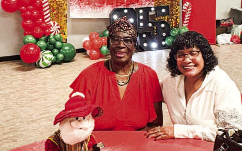 Pictured are Margaret Golightly and Marilyn Demons at the 25th annual Circle of Sisters event this past Saturday. The event is held on the second Saturday in December and allows for ladies of the Northside community to come together for food, fun and fellowship. Golightly and Demons graduated from high school together and the event allows them to catch up. (Staff photo)
