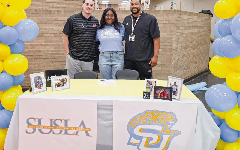JOYCE SIGNS WITH SUSLA - Levelland Loboette Sydnii Joyce committed to Southern University Shreveport Louisiana to play collegiate basketball this past Wednesday in the Levelland High School commons area. Pictured with Joyce are Levelland’s Coach Bell (left) and Coach Flemmons (right). The SUSLA Lady Jags compete in NJCAA Division 1. (Photo provided by Levelland ISD)