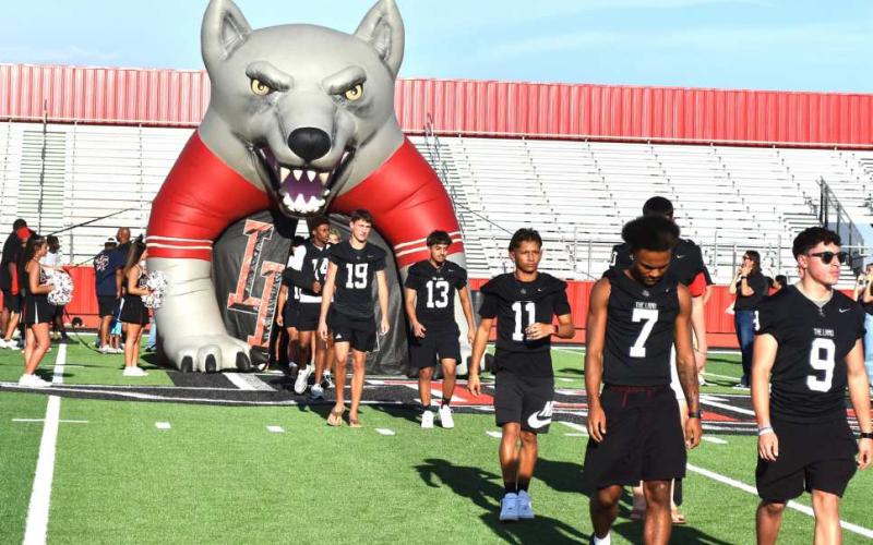 MEET THE LOBOS - Athletes, band members, cheerleaders, fans, parents and school administration joined in to kick off the 2026 f all sports season this pas t Friday as well as cut the ribbon on the HCCU Lobo St adium. (staff photo)