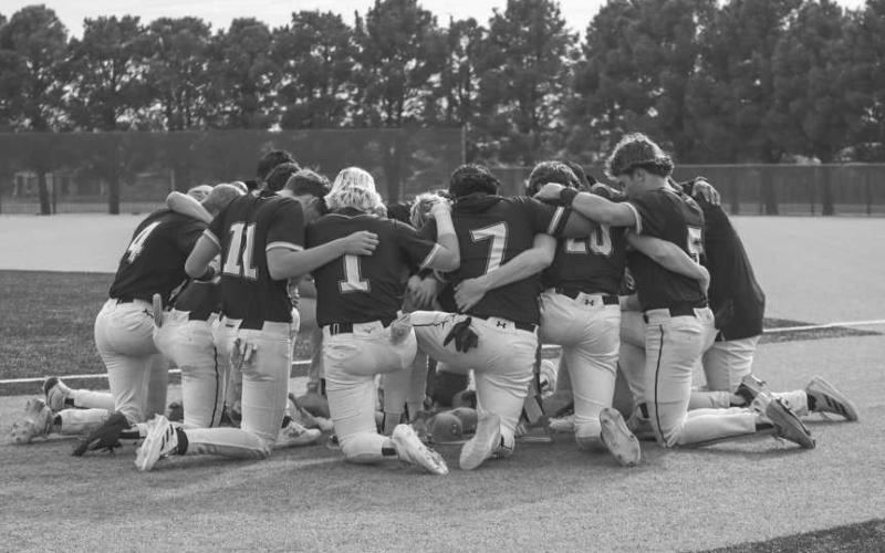 PRAY - The Ropes Eagles prayed before their game against the New Deal Lions this past Thursday night at the Littlefield Baseball Field. (Staff photo by Aalijah Soliz)