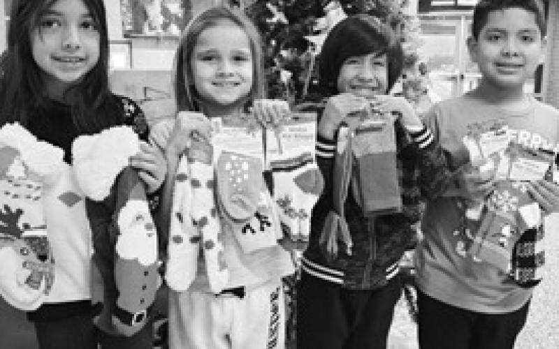 Capitol kids enjoyed Cozy Winter Day. The kids got to wear cozy socks and donate a pair of cozy socks to the local senior citizens. Pictured from left to right are Arysai Reyes, Makenzie Del Campo, Nicholas Garza, Arturo Erreguin. (Photo submitted by Cristal Isaacks)
