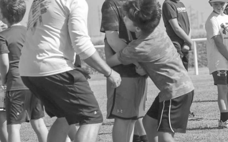 DEFENSE - Whitharral Panthers Thiago Rendon and Braxton Wecker were learning how to tackle properly last Monday with Whitharral Coach Jeremy Holt teaching them along the way. (Staff photo by Aalijah Soliz)