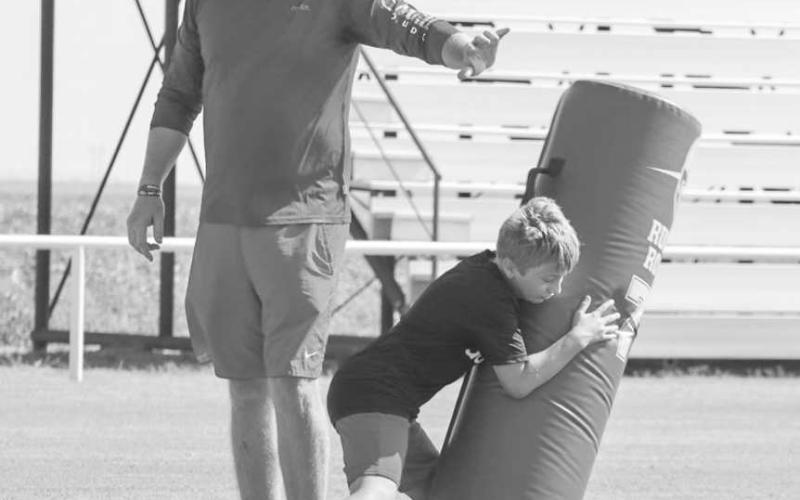 FORM TACKLING - Whitharral Coach Matt White watched Panther Braden Spies tackle the dummy with perfect form last Monday at the Whitharral All-Sports Camp. (Staff photo by Aalijah Soliz)