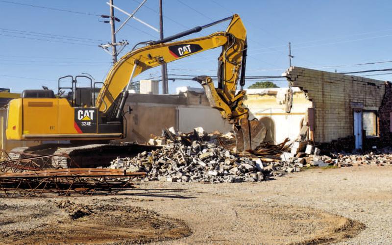 DEMOLITION - The demolition of the building formally known a Mexiteria Restaurant located on the corner of Maple Street and College Avenue. Demolition of the building began last Thursday. (Staff photo by Emily Campos)