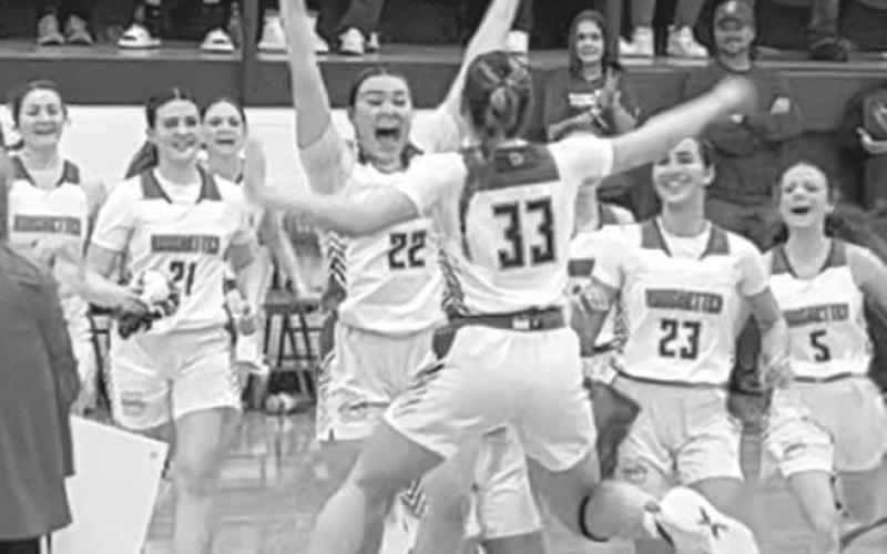 RECORD - Right after Allie McCormick scored her 100th point, the team called a timeout to celebrate her, including Coach Kim Watson and her teammates as they jump around with her. (Photo courtesy of Amber Wisdom)