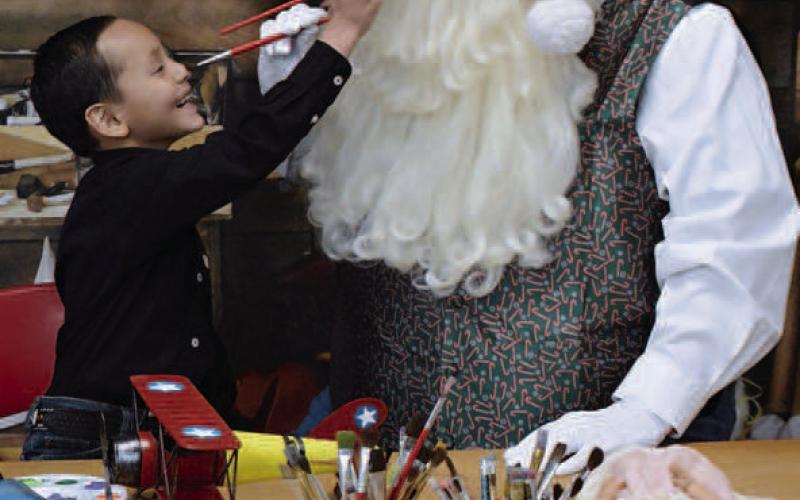 FUN AT SANTA’S WORKSHOP– Kohan Valderas, 6, had a blast while helping Santa Claus at Santa’s Workshop recently. Fire Angel Photography of Levelland hosted Santa’s Workshop where children and adults of all ages could have their photo taken while having fun with Santa. Children could wear elf ears and become an honorary elf. (Submitted Photo)