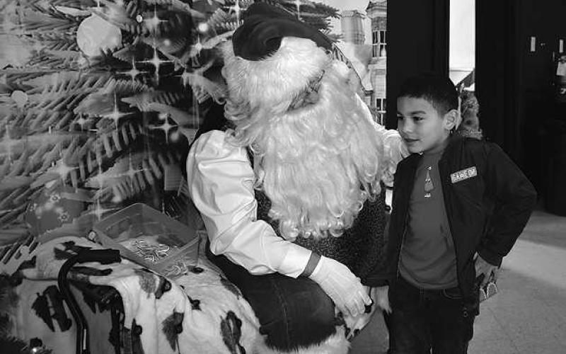 DEAR SANTA– Levelland Academic Beginnings Center kindergarten students from Mrs. Flores and Mrs. Almanza’s class enjoyed visiting with Santa, activities and a movie at the Wallace Theater recently. (Staff Photo by DeeLaine Ruiz)
