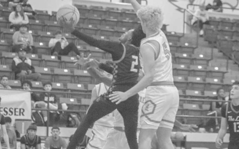 UPAND UNDER - Levelland Lobo Elijah Jordan layed the ball up through the contact against the Monterey Plainsmen this past Thursday in Frenship. (Staff photo by Aalijah Soliz)
