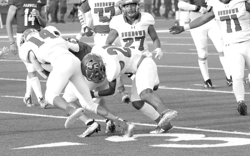 LOSS OF YARDS- The Sundown Roughnecks fell to Farwell, 49-0. Koy Torres and Ricky Melendez work together to bring down a Farwell player for a loss of yards. Sundown will welcome Wink into for homecoming Friday September 16. Kick is scheduled for 7:30 p.m. (Photo Courtesy of Chris Bratcher)