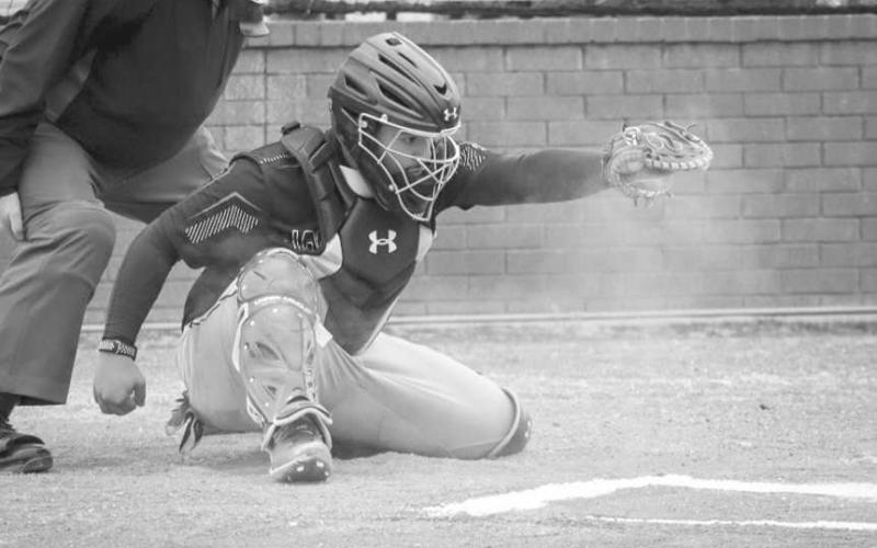 STRIKE - Levelland Lobo R.J. Mireles caught the pitch from Boston Winfield this past Tuesday night against the Shallowater Mustangs at home. (Staff photo by Aalijah Soliz)