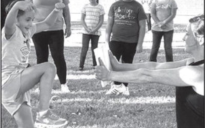 MARTIAL ARTS-- Capitol Elementary PE teacher Ms. Kristy Sanders, arranged for Premier Martial Arts to come and involve students and parents in a Family Fitness Night. Second grade student Layla Carranza was learning a martial arts move. (Submitted Photo)