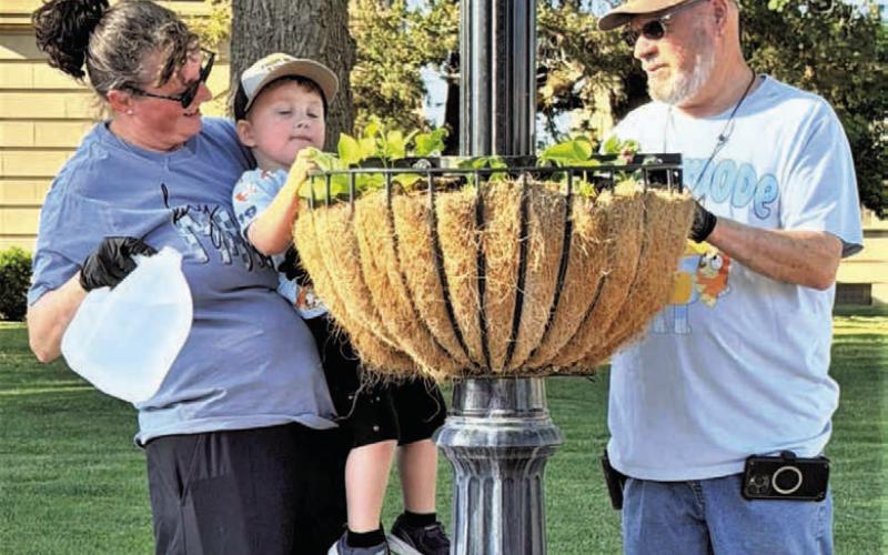 DRINK UP- Community members worked this past Saturday cleaning out planters containing the spring plants and adding live plants for the summer months. (City of Levelland Main Street photo)