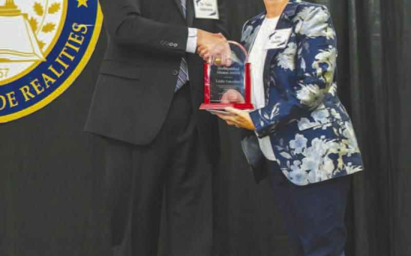 DISTINGUISHED ALUMNI AWARD WINNER - South Plains College President Robin Satterwhite (left) honors Leslie Valentine, senior regional product creation director at Nike, with the Distinguished Alumni Award during the college’s annual Scholarship Banquet on Nov. 7 at the Mallet Event Center in Levelland. (SPC Photo)