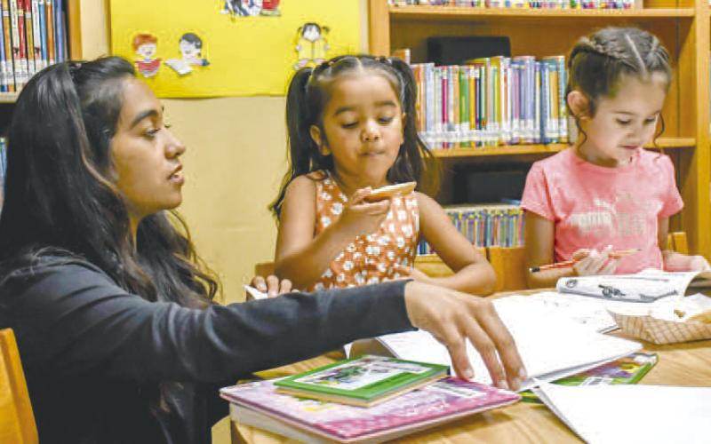 MAKINGMEMORIES ONE CRAYONATATIME - Pictured left to right are Esperanza Alcantra, Catalina Chavez and Sophia Chavez at the Books and Bagels event held at the Hockley County Memorial Library held on Wednesday. (Staff photo by Hannah Woodrum)