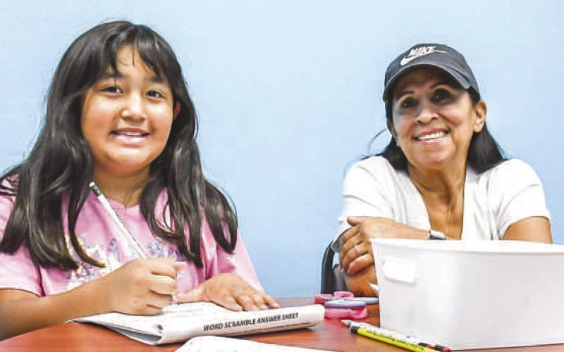 SMILESALLAROUND – Pictured are Devenee (right) and Sandy Jaramilla (left) enjoyed their Wednesday morning at the Books and Bagels event held at the Hockley County Memorial Library. The library will have three more events before they wrap up their summer book program. (Staff photo by Ada Niederhauser)