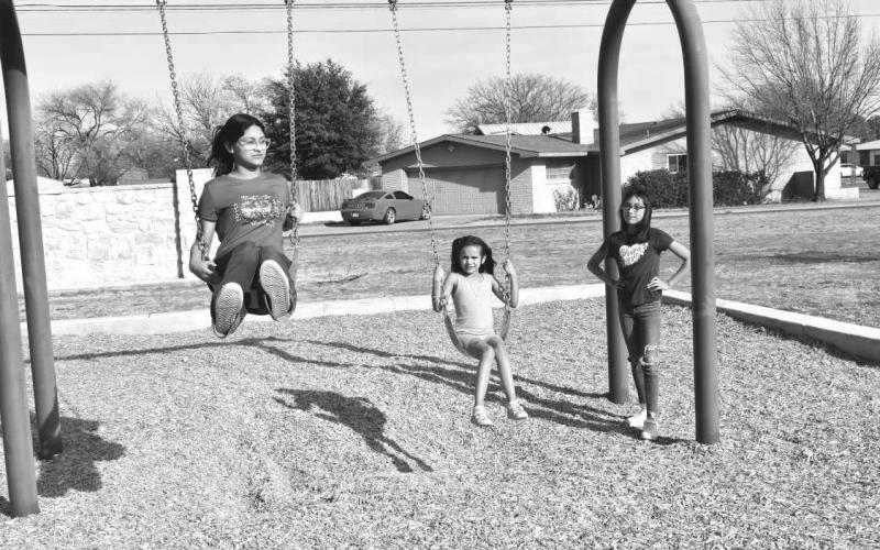 ENJOYING SPRING BREAK- Tuesday was the perfect weather to have fun in the park . In photo sisters Lilliey Barrera, Annavey Barrera, and cousin Keyna Gonzales are enjoying there free time from school to have fun at Barlett Park .(Staff photo by Emily Campos)