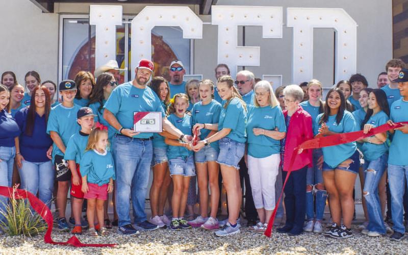 HTEAO - Newly constructed, HTeaO held their grand opening and a ribbon cutting Friday morning. Community members packed the area in support of the new business. Pictured are owners Brian and Ashley Becton along side their daughters Kyleigh Kynslie and Kambryn Becton, Greenstreet construction, HTeaO staff, HTeaO Corporate, Sundown State Bank along with family and friends. (Photo courtesy of Emily Campos)