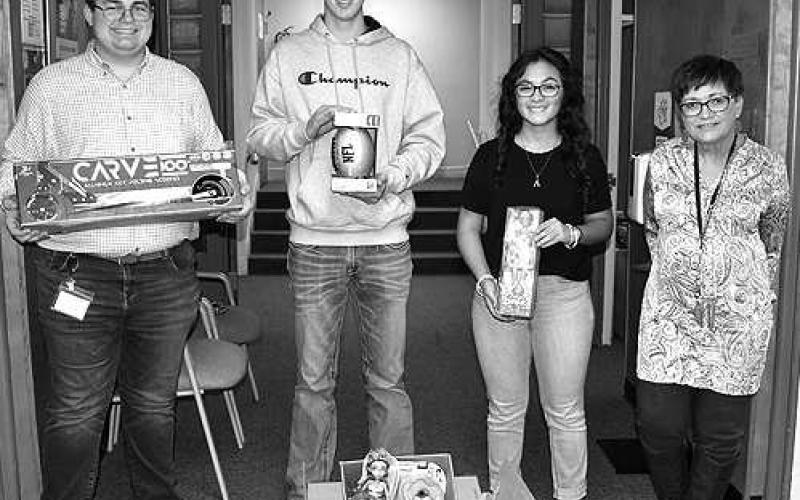 YELLTOYDONATION– LHS Young Emerging Leaders of Levelland (YELL) held its annual Toy Drive during the month of November as one of its community service projects. YELL members, Grayson Edens, Zachary Swain and Alanis Valderas, donated several boxes of toys collected for Love Levelland toy drive. Accepting the toys is Public Assitant Administrator, Cara Phelan. (Staff Photo by DeeLaine Ruiz)