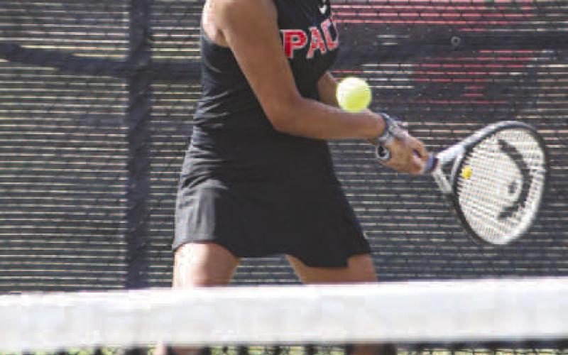 SENDIN’ IT BACK – LHS Tennis Packs Lilly Alvarado made a two-handed backhand play on the ball to send it back towards her opponent during a tennis match against All Saints on August 12. (Staff photo by Jentezen Smith)