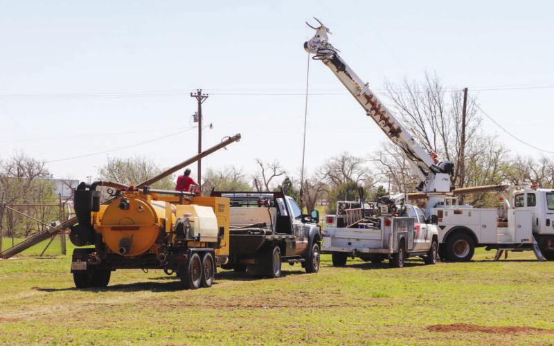 MAKING REPAIRS - A K-BAR Electric crew was pictured early in the week working on a city water well after its power pole had been damaged due to the severe storm on May 29. Electric companies have been working around the clock to repair damaged power poles and lines that were affected by the storm. (Staff photo by Emily Campos)
