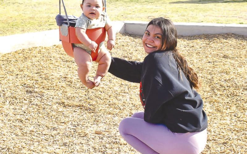 FUN IN THE SUN - Kayla Chavez and her daughter Royalty Gutierrez enjoyed their time playing on the swings at Bartlett Park Monday afternoon. Bartlett Park also includes a two playground areas, a wide-open grass area, a basketball area, a pavillian and recently installed Gaga Ball area. Bartlett Park is one of 13 parks and 14 playgrounds that span the City of Levelland. (Staff photo by Emily Campos)